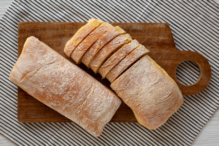 Homemade Ciabatta Bread on a wooden board, top view.