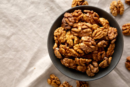 Raw Walnut Halfs in a Bowl, top view. Flat lay, overhead. Copy space.の写真素材