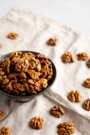 Raw Walnut Halfs in a Bowl, side view.