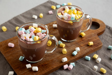 Warm Chocolate Cocoa in Mugs with Colorful Marshmallows, side view.の写真素材