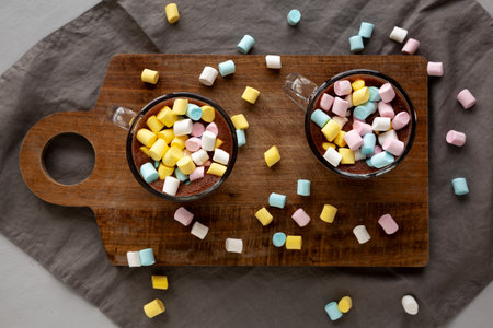 Warm Chocolate Cocoa in Mugs with Colorful Marshmallows, top view. Overhead, from above.の写真素材