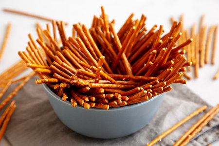 Organic Salty Pretzel Sticks in a Bowl, side view.