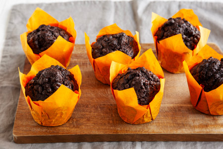 Homemade Chocolate Chip Muffins on a wooden board, side view.の写真素材