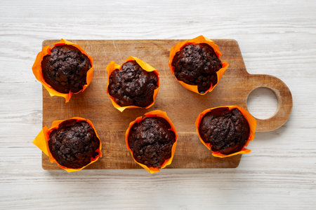 Homemade Chocolate Chip Muffins on a wooden board, top view.の写真素材