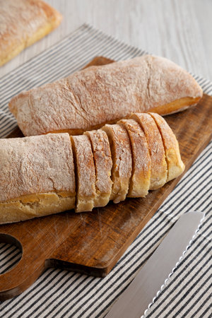 Homemade Ciabatta Bread on a wooden board, side view.の写真素材