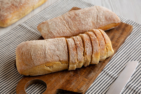 Homemade Ciabatta Bread on a wooden board, side view.の写真素材