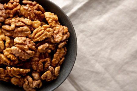 Raw Walnut Halfs in a Bowl, top view. Flat lay, overhead. Copy space.の写真素材