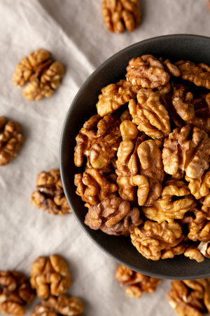 Raw Walnut Halfs in a Bowl, top view. Flat lay, overhead. Close-up.の写真素材