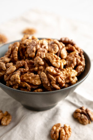 Raw Walnut Halfs in a Bowl, side view. Close-up.の写真素材