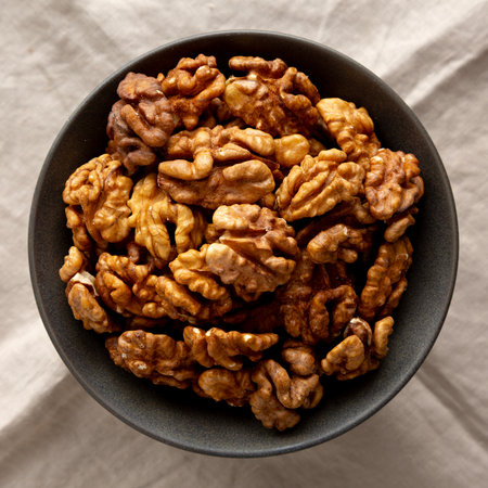 Raw Walnut Halfs in a Bowl, top view. Flat lay, overhead.の写真素材