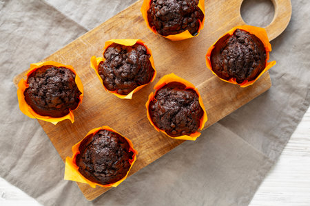 Homemade Chocolate Chip Muffins on a wooden board, top view.の写真素材