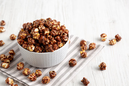 Homemade Chocolate Caramel Popcorn Ready to Eat in a Bowl, side view.の写真素材