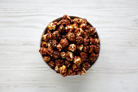 Homemade Chocolate Caramel Popcorn Ready to Eat in a Bowl, top view.の写真素材