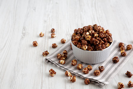 Homemade Chocolate Caramel Popcorn Ready to Eat in a Bowl, side view.の写真素材