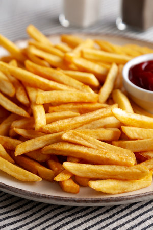 Homemade Golden French Fries with Ketchup, side view. Close-up.の写真素材