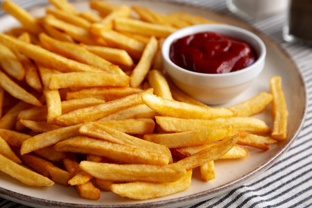Homemade Golden French Fries with Ketchup, side view. Close-up.の写真素材