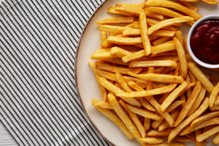 Homemade Golden French Fries with Ketchup, top view. Copy space.の写真素材
