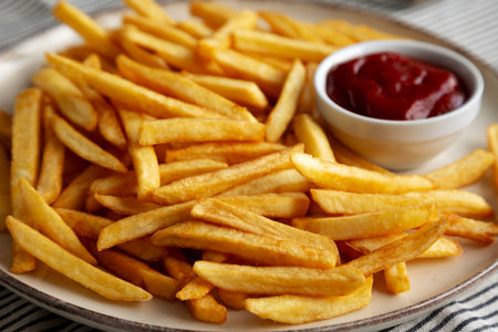 Homemade Golden French Fries with Ketchup, side view. Close-up.の写真素材