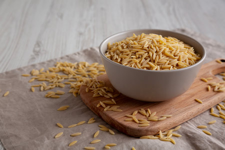 Organic Dried Orzo Pasta in a Bowl, side view. Copy space.の写真素材