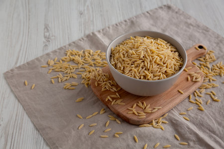 Organic Dried Orzo Pasta in a Bowl, side view. Copy space.の写真素材