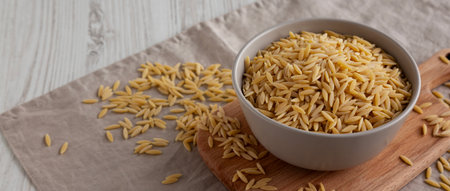 Organic Dried Orzo Pasta in a Bowl, side view.の写真素材