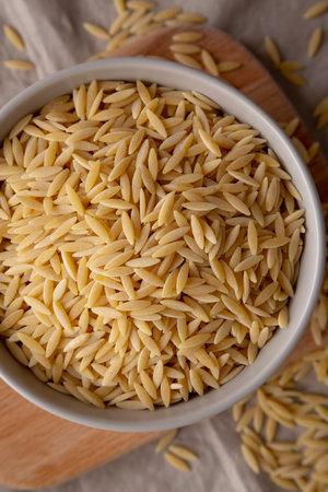 Organic Dried Orzo Pasta in a Bowl, top view.の写真素材