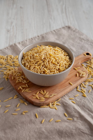 Organic Dried Orzo Pasta in a Bowl, side view.の写真素材