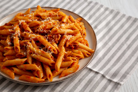Homemade Pasta Bolognese with Cheese on a Plate, side view. Copy space.の写真素材