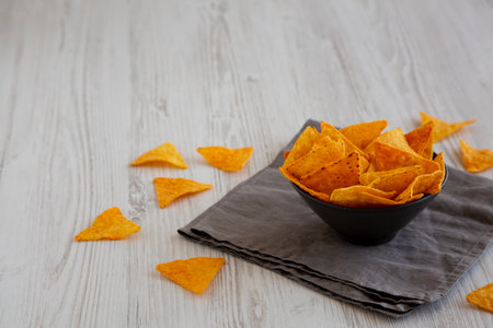 Crunchy Nacho BBQ Tortilla Chips in a Bowl, side view. Copy space.の写真素材