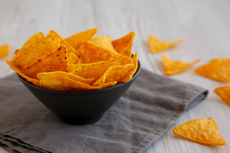 Crunchy Nacho BBQ Tortilla Chips in a Bowl, side view. Close-up.の写真素材