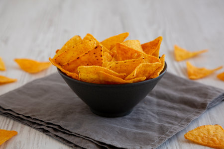 Crunchy Nacho BBQ Tortilla Chips in a Bowl, side view. Close-up.の写真素材