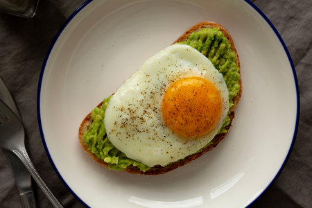 Homemade Avocado Toast with Egg on a Plate, top view.の写真素材