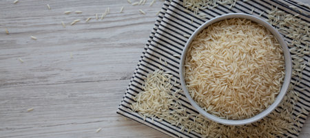 Uncooked White Organic Basmati Rice in a Bowl, top view. Copy space.