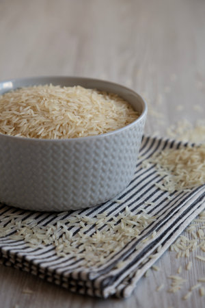Uncooked White Organic Basmati Rice in a Bowl, side view. Close-up.の写真素材
