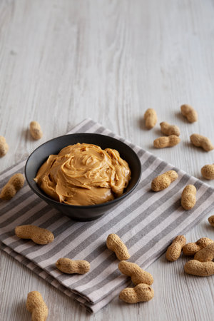Organic Creamy Peanut Butter in a Bowl, side view. Copy space.の写真素材