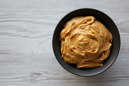 Organic Creamy Peanut Butter in a Bowl, top view. Copy space.の写真素材