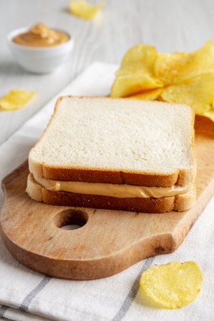 Homemade American Peanut Butter Sandwich and Potato Chips, side view.の写真素材