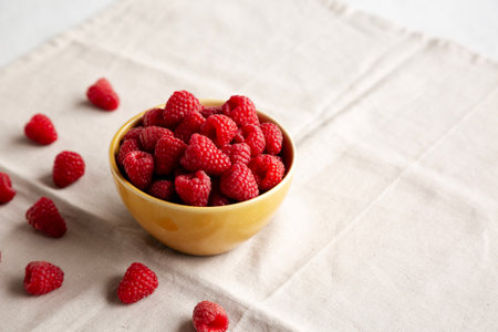Organic Raw Red Raspberries in a Bowl, side view. Copy space.の写真素材