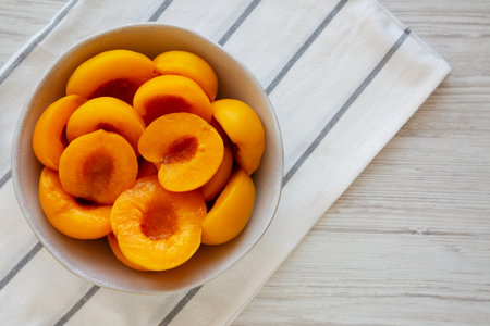 Healthy Organic Canned Peach Halves in a Bowl, top view.の写真素材