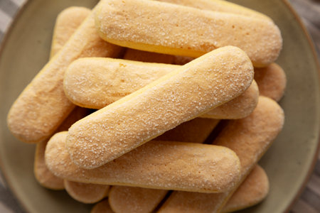 Savoiardi biscuits on a plate, top view. Close-up.