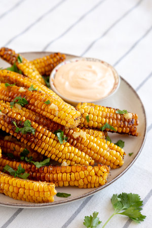 Homemade Spicy Corn Ribs with Mayo on a Plate, side view.の写真素材