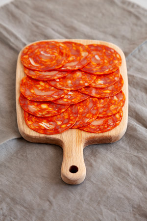 Cold Meat Chorizo Slices on a Wooden Board, side view.の写真素材