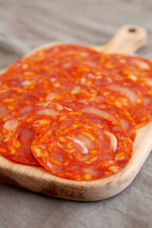Cold Meat Chorizo Slices on a Wooden Board, side view. Close-up.の写真素材
