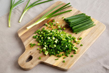 Organic Green Chopped Chives on a Wooden Board, side view.の写真素材