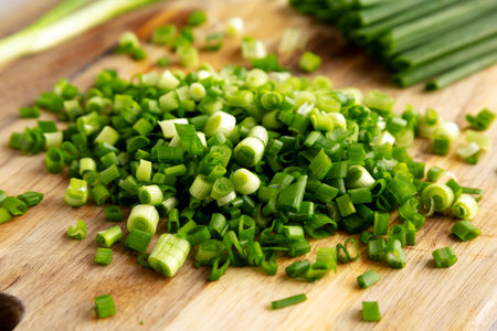 Organic Green Chopped Chives on a Wooden Board, side view. Close-up.の写真素材