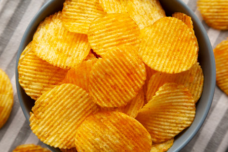 Crinkle Potato Chips with Chorizo Sausages and Onions Flavor in a Bowl, top view.
