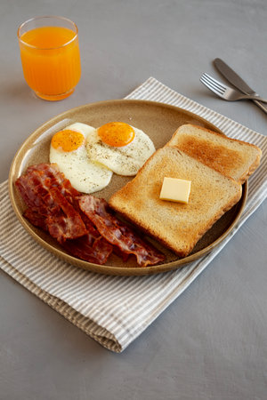 Homemade American Bacon Egg and Toast Breakfast on a Plate, side view.の写真素材