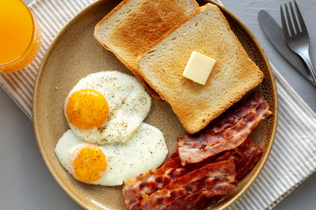 Homemade American Bacon Egg and Toast Breakfast on a Plate, top view.