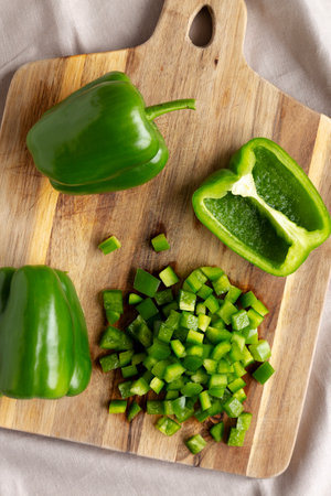 Organic Chopped Green Bell Peppers arranged on a Cutting Board, top view.の写真素材