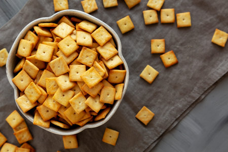 Salty Cheese Cracker Squares in a Bowl, top view. Overhead, from above.